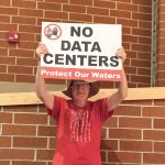 Alm holding sign